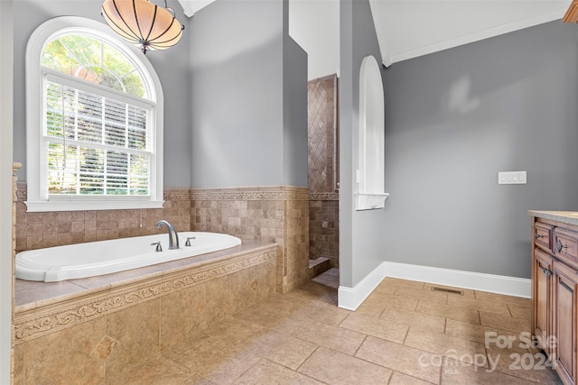 bathroom with vanity, ornamental molding, a wealth of natural light, and plus walk in shower