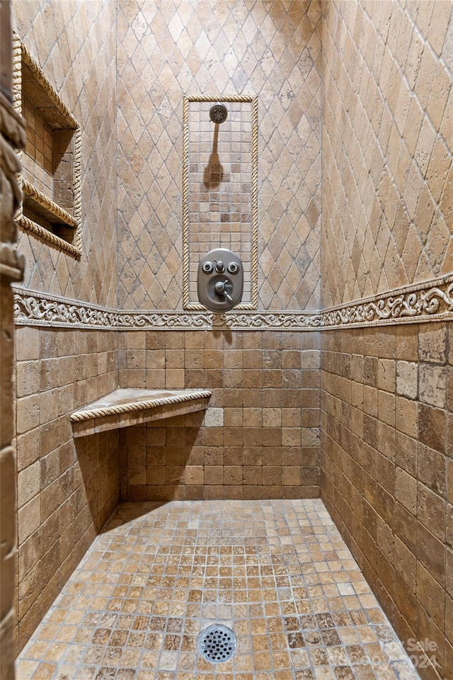 bathroom with tiled shower