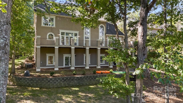 rear view of property featuring central AC and a balcony