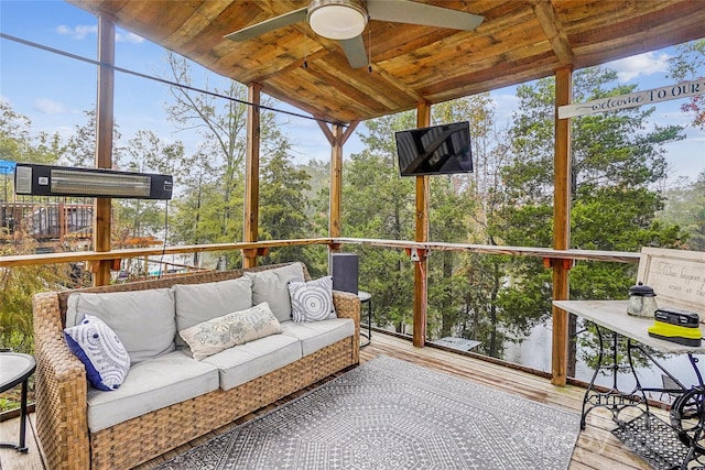 sunroom / solarium with wood ceiling, ceiling fan, and a wealth of natural light