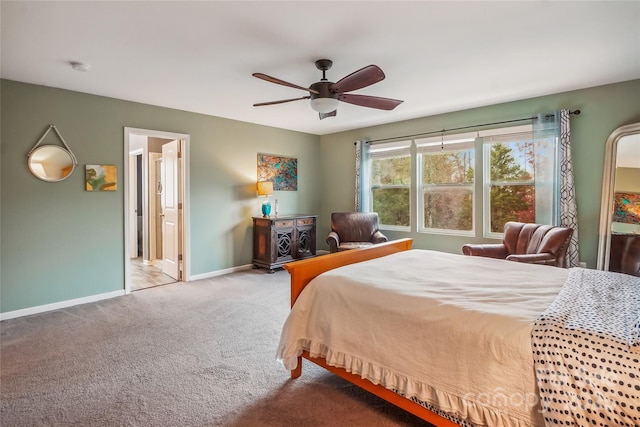 carpeted bedroom with connected bathroom, baseboards, and a ceiling fan