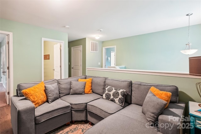 living room featuring wood finished floors and visible vents