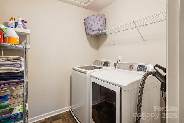 clothes washing area with laundry area, baseboards, dark wood finished floors, and independent washer and dryer