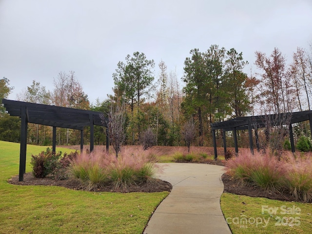 surrounding community featuring a yard, concrete driveway, and a pergola