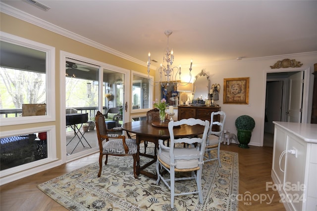 dining room featuring a wealth of natural light, crown molding, and parquet flooring