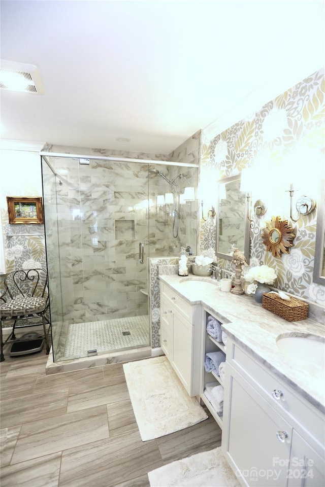 bathroom featuring walk in shower and vanity