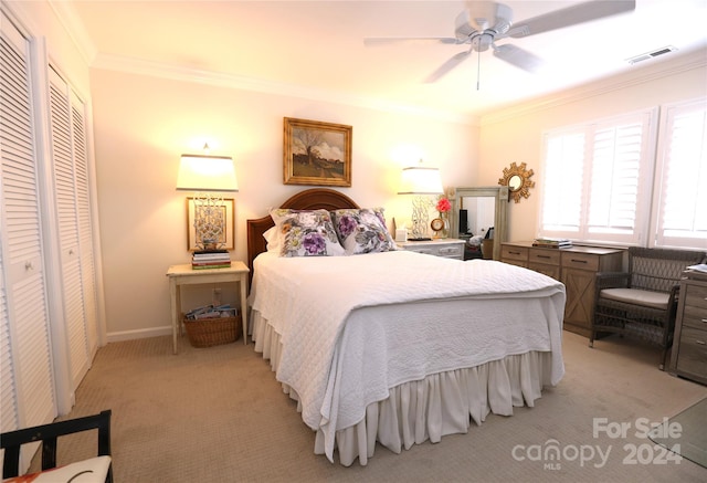 carpeted bedroom featuring a closet, ceiling fan, and crown molding