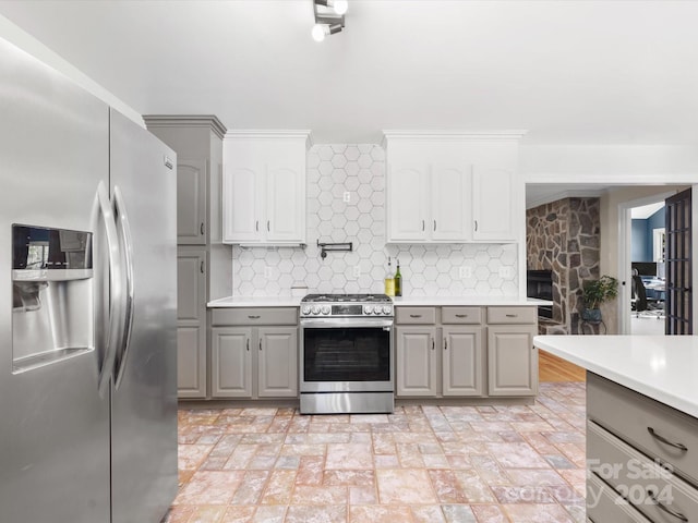 kitchen featuring gray cabinetry, tasteful backsplash, and appliances with stainless steel finishes