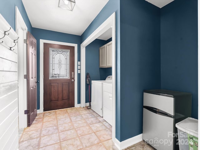 washroom featuring light tile patterned flooring, independent washer and dryer, and cabinets