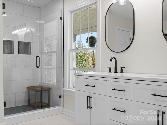 bathroom with vanity, walk in shower, and tile patterned floors