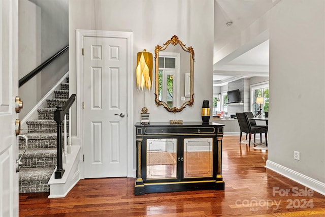 entryway featuring wood-type flooring and decorative columns