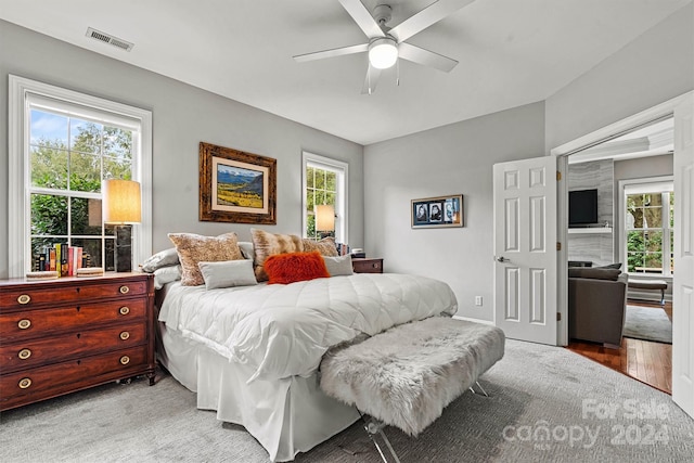 bedroom with light hardwood / wood-style floors and ceiling fan