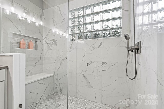 bathroom with tiled shower