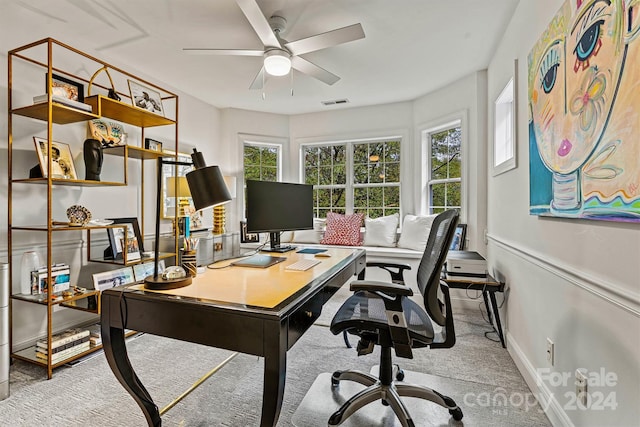 carpeted home office with ceiling fan