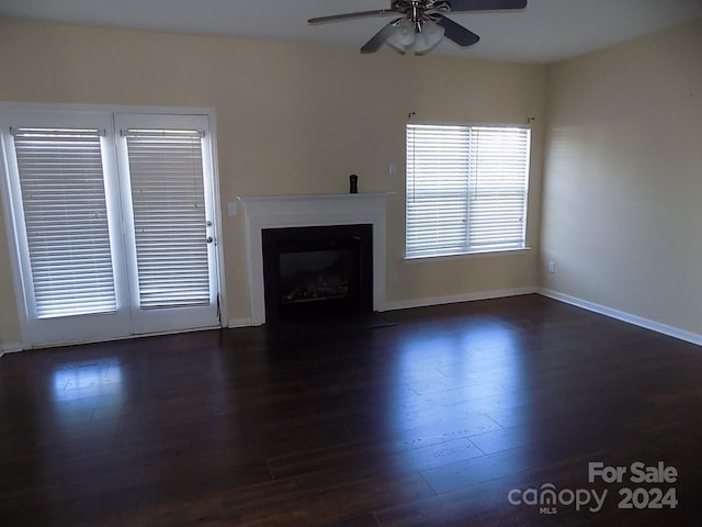 141 Rock Ridge Ln, Mount Holly, NC 28120 - unfurnished living room with dark wood-style floors, a ceiling fan, a fireplace with flush hearth, and baseboards