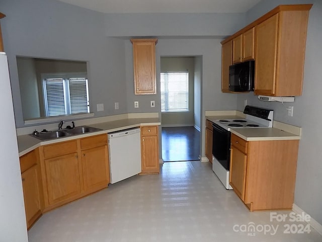 141 Rock Ridge Ln, Mount Holly, NC 28120 - kitchen featuring white appliances, a sink, baseboards, light countertops, and light floors