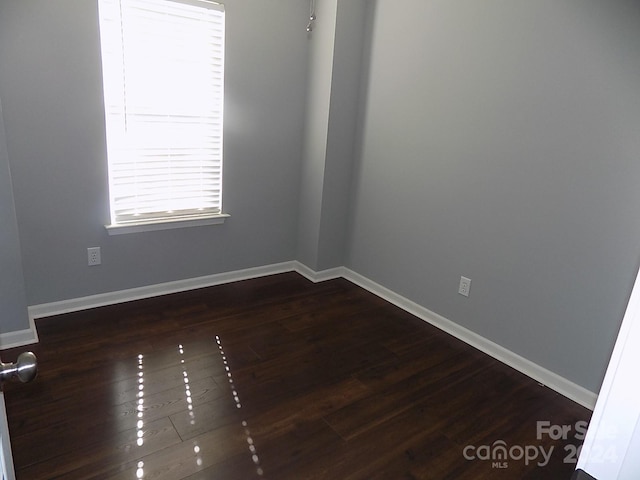 unfurnished room featuring dark hardwood / wood-style floors