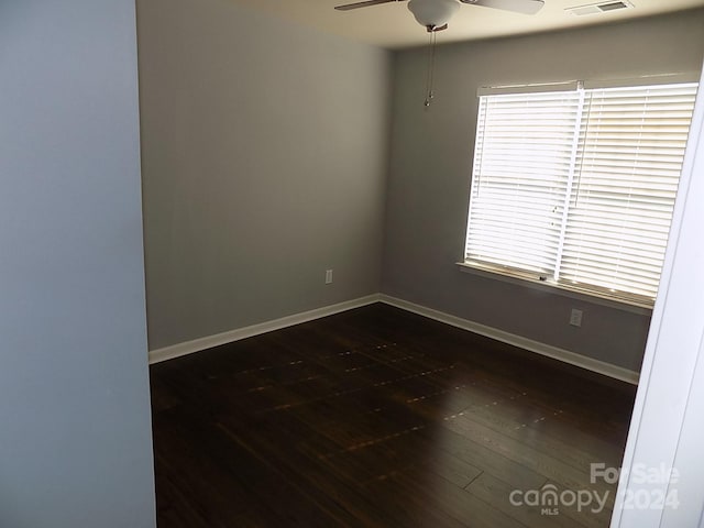 unfurnished room featuring ceiling fan and dark hardwood / wood-style floors