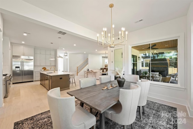 dining area with sink and light hardwood / wood-style flooring