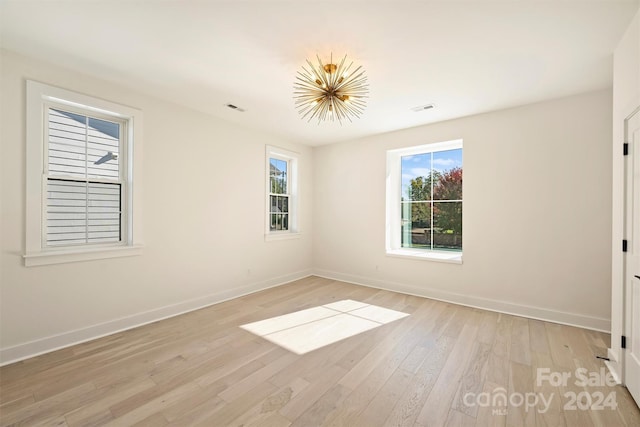 spare room featuring light hardwood / wood-style floors