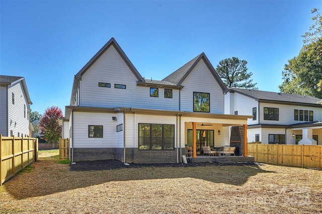 rear view of property featuring ceiling fan