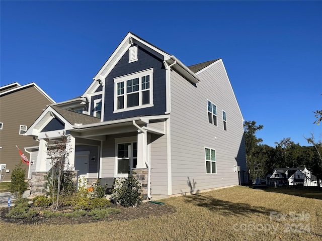 craftsman-style home with a porch and a front yard