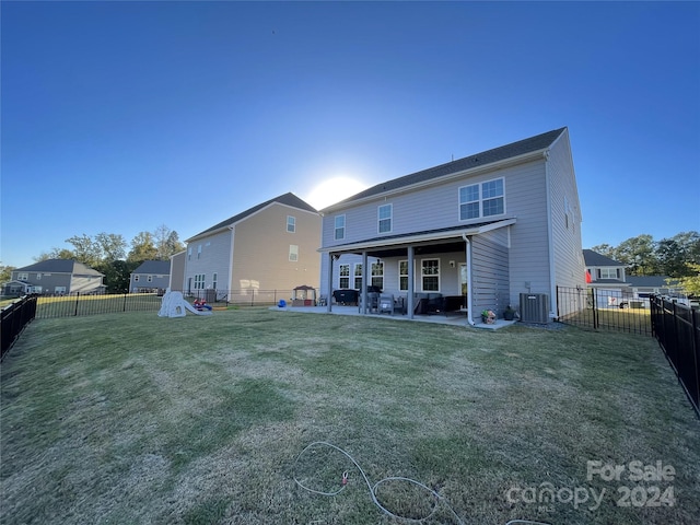 back of house with a patio area and a yard