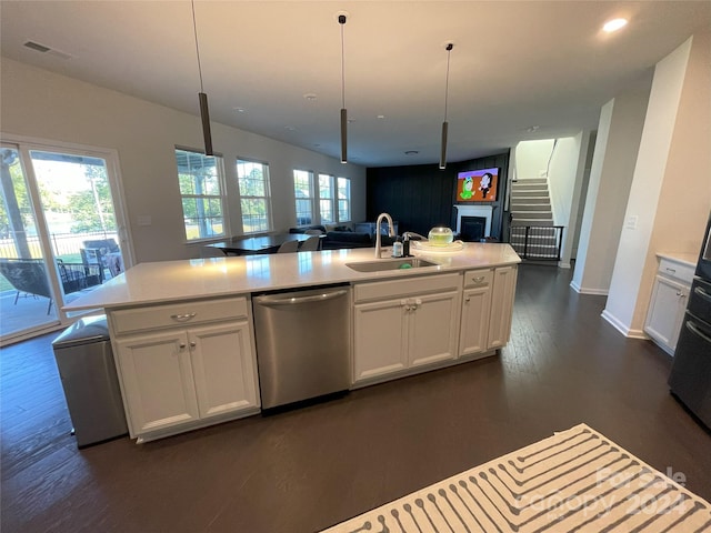 kitchen featuring white cabinetry, sink, stainless steel dishwasher, and dark hardwood / wood-style flooring