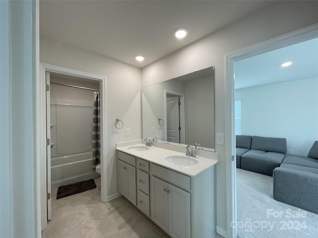 full bathroom featuring toilet, shower / tub combo with curtain, and vanity