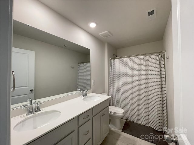 bathroom featuring vanity, toilet, and walk in shower