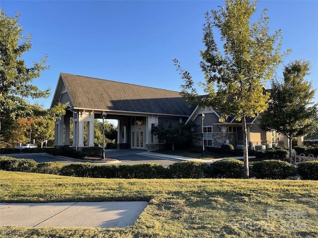 view of front facade with a front yard and french doors