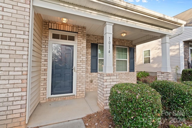 view of exterior entry with covered porch