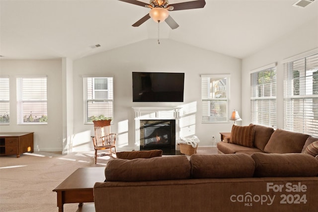 living room featuring carpet flooring, ceiling fan, and vaulted ceiling