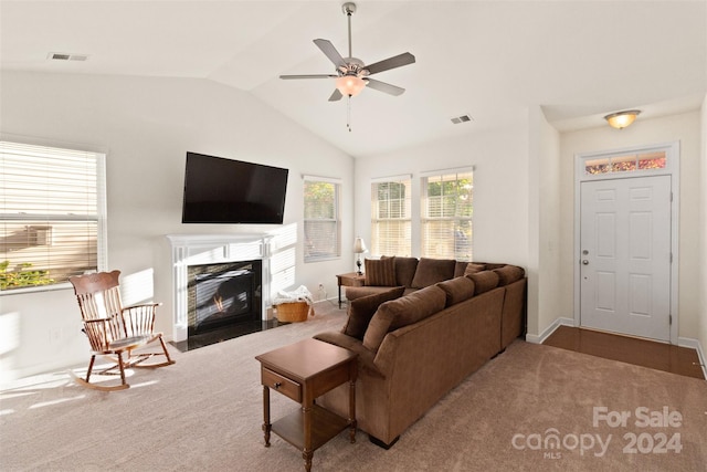 living room featuring ceiling fan, carpet floors, and vaulted ceiling