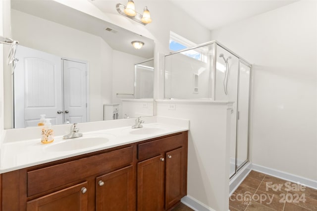 bathroom featuring tile patterned floors, vanity, and walk in shower