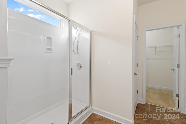 bathroom featuring tile patterned flooring and a shower with door