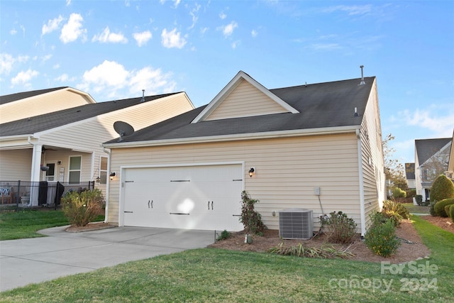 view of property exterior featuring central AC unit, a garage, and a yard