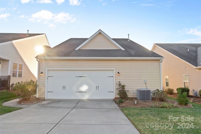 exterior space featuring central AC and a garage