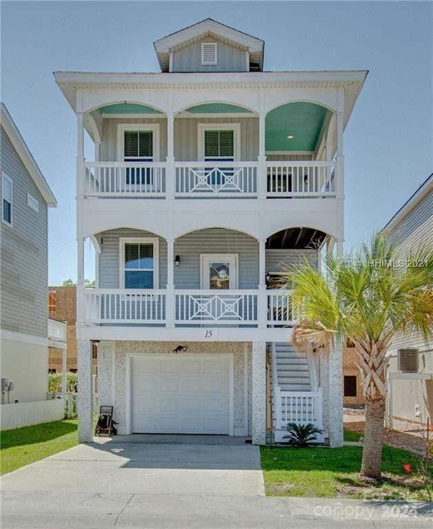 coastal home featuring a balcony and a garage