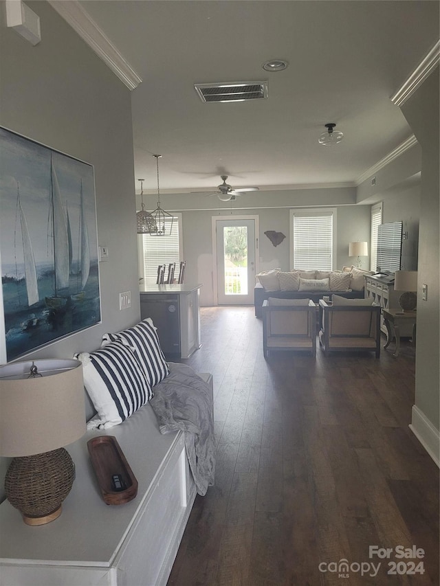 living room with ceiling fan, ornamental molding, and dark hardwood / wood-style flooring