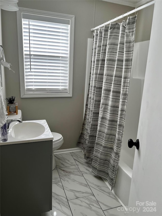 full bathroom with vanity, shower / bath combo with shower curtain, and toilet