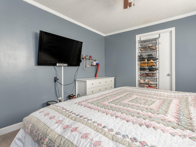 bedroom with crown molding, carpet flooring, ceiling fan, a textured ceiling, and a closet