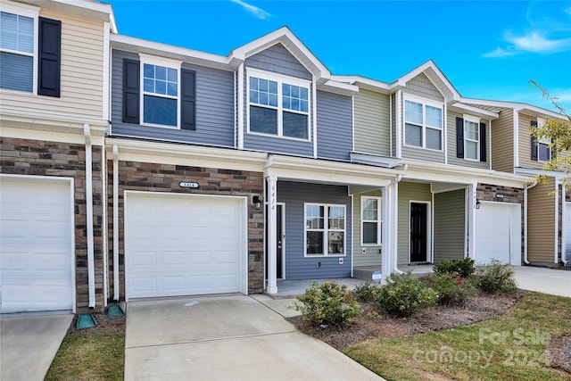 townhome / multi-family property featuring a garage