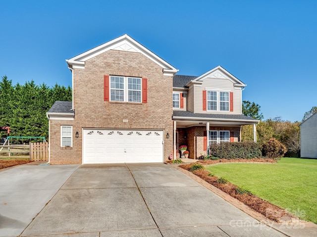 view of front property with a garage and a front yard