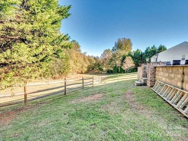 view of yard with a rural view