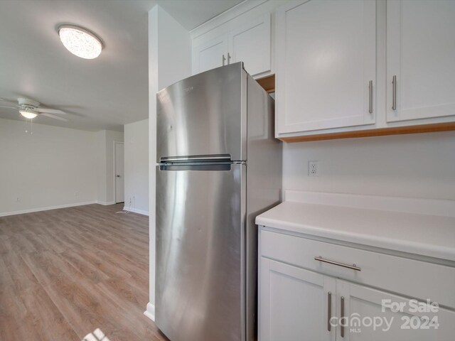 kitchen featuring white cabinetry, stainless steel fridge, ceiling fan, and light hardwood / wood-style floors