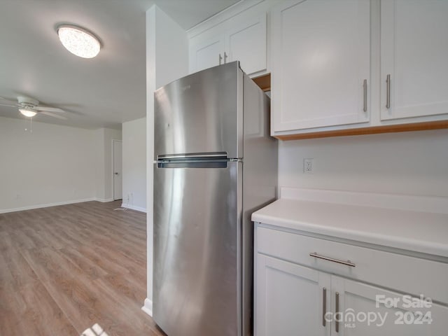 4605 Coronado Dr Unit M, Charlotte, NC 28212 - kitchen with freestanding refrigerator, ceiling fan, light countertops, white cabinetry, and light wood finished floors