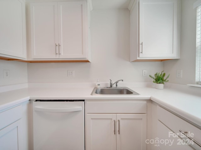 kitchen with sink, dishwasher, and white cabinets