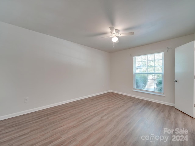 unfurnished room with light wood-type flooring and ceiling fan