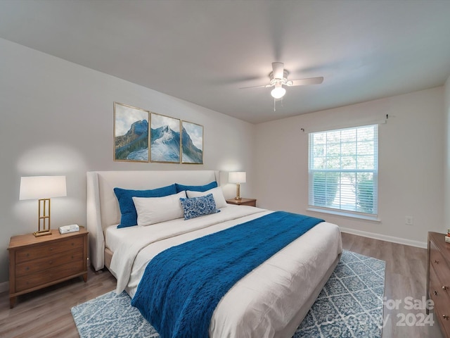 bedroom with wood-type flooring and ceiling fan